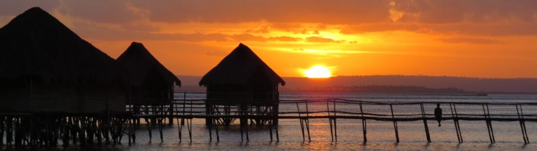 sunset with huts in Mozambique